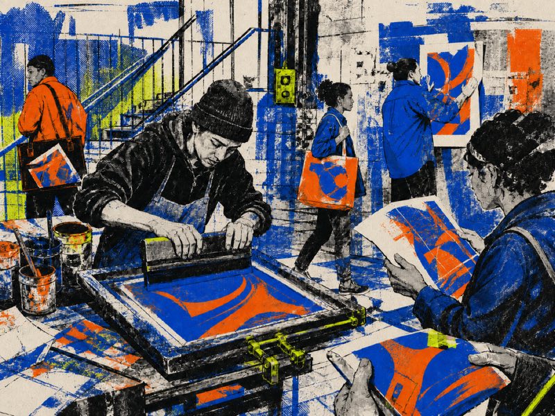 People screen-print, fold, post, and carry related cobalt-and-orange artifacts through a distressed urban workshop.